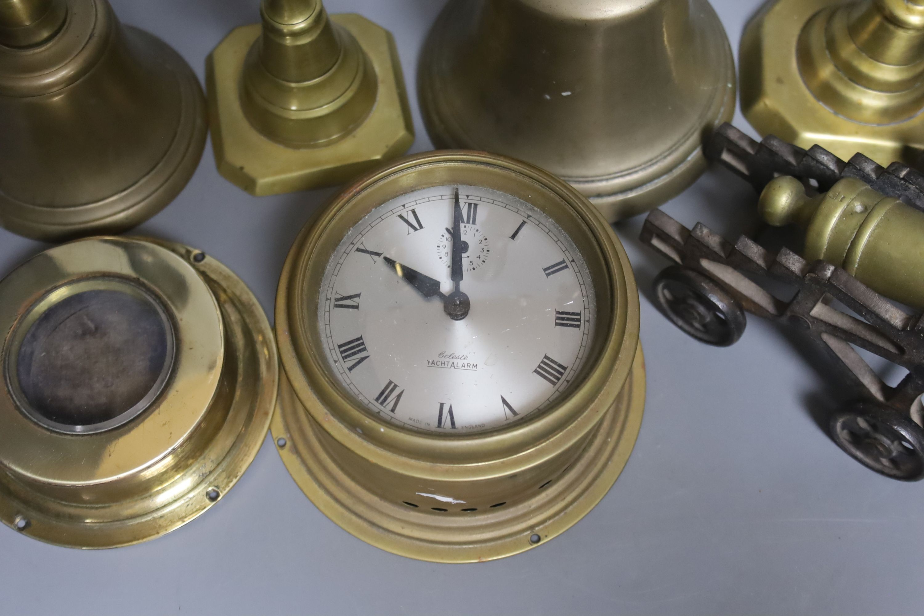 A quantity of brassware including bells, model cannons, candlesticks etc.